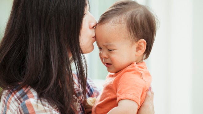 mom kissing crying baby