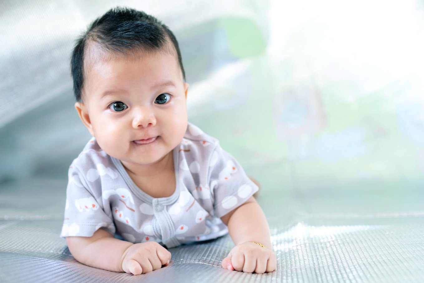 Baby wearing a gray shirt