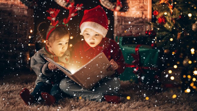 Brother and sister reading a Christmas book