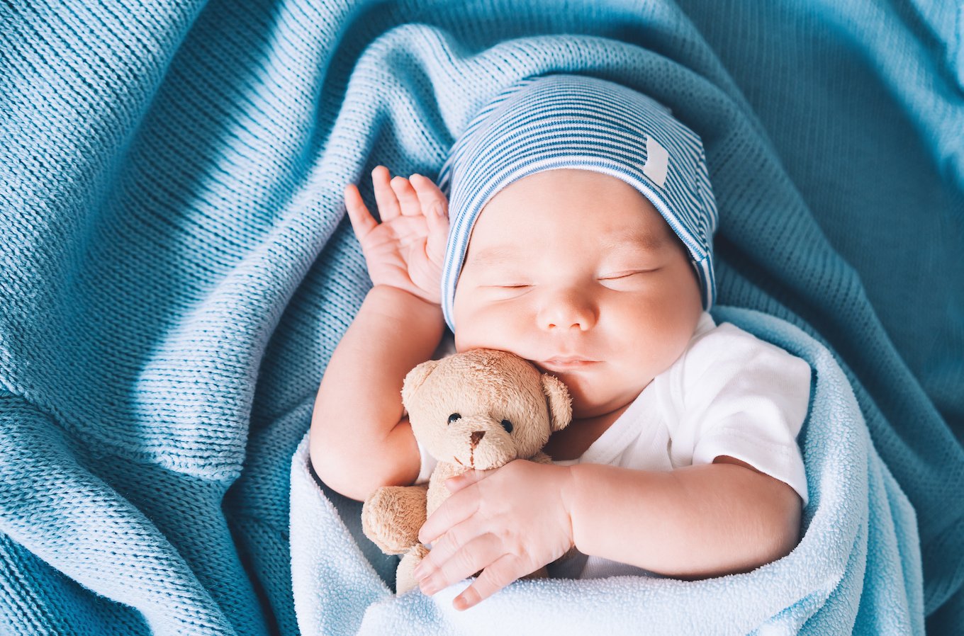 Baby holding a teddy bear