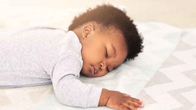 when can a baby sleep on his stomach