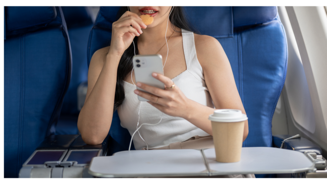 Woman eating on airplane
